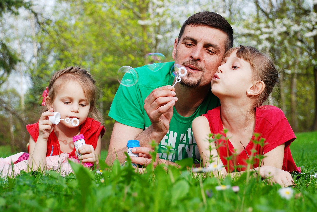 Dad engaging in healthy play with kids in summer