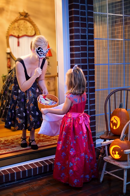 Butterfly Beginnings Counseling tips for stress-free Halloween image of woman giving tirck-or-treating child treats