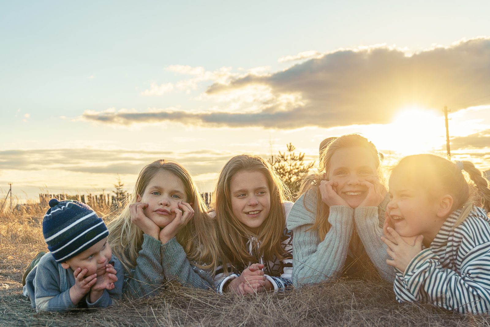 Kids sitting in the sun for article about Life Tasks by Kim Feeney at Butterfly Beginnings Play Therapy in Davenport, Iowa