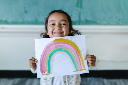 Child holding art activity indoor activities from Butterfly Beginnings Play Therapy