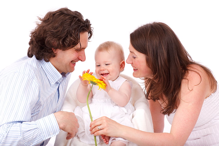 Image of parents smiling at happy toddler for butterfly beginnings play therapy in iowa blog: Attachment and your child's mental health