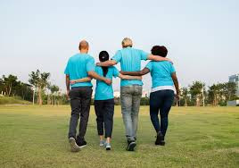 Image of happy family with teens walking together for butterfly beginnings play therapy in iowa blog: Preventing Enmeshment
